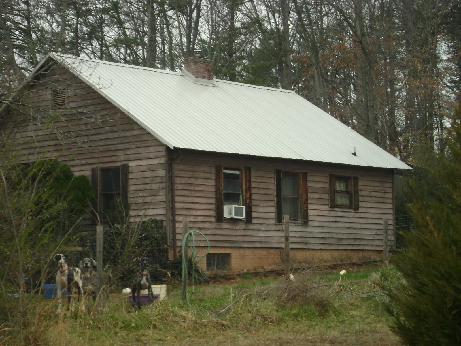 White metal roof on an old wood sided farmhouse, from a Metal Roof Installation job in Elizabeth